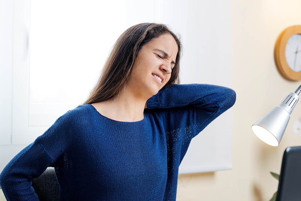 Teen student suffers neck pain with computer at home