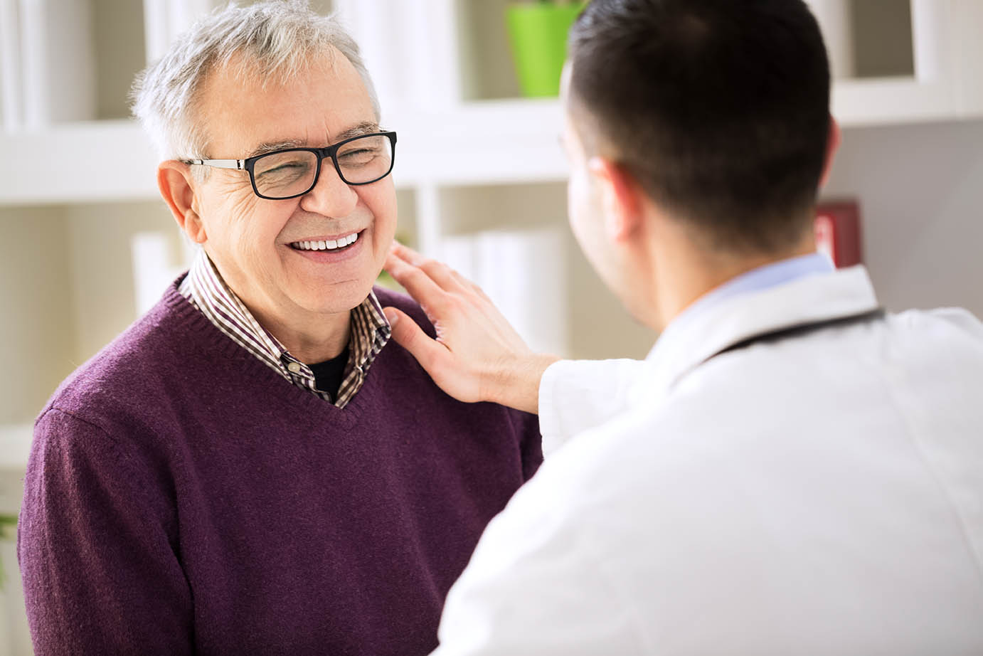 Smiling happy old patient visit doctor